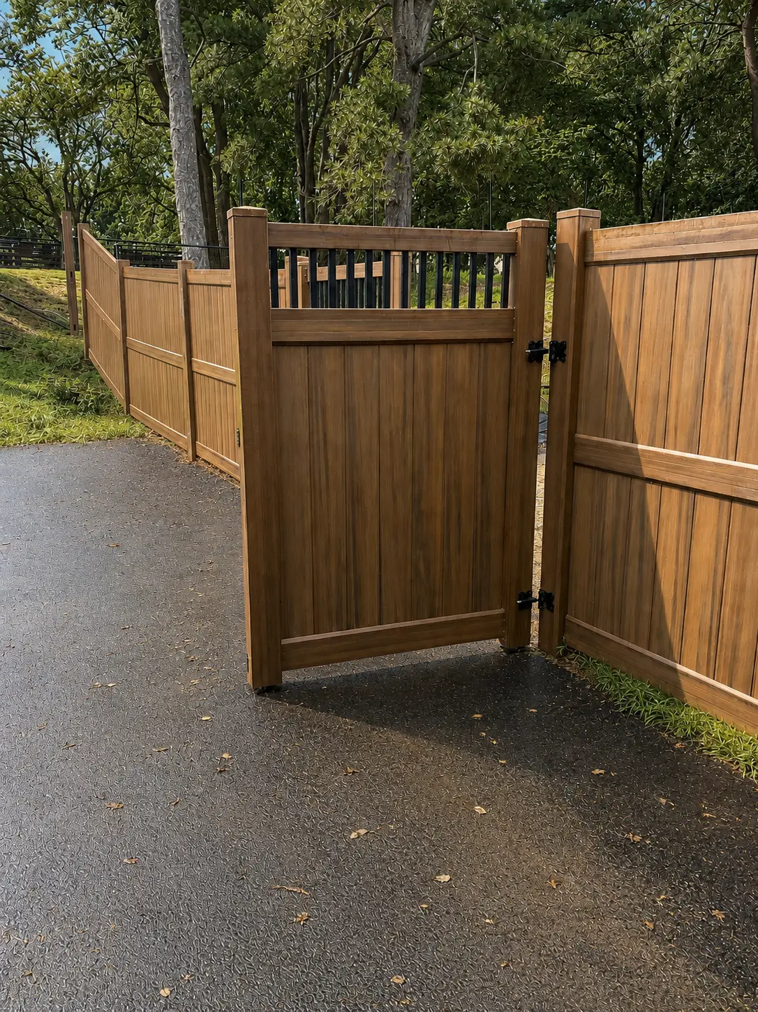 Wood-grain privacy fence with matching gate along a driveway in New Jersey
