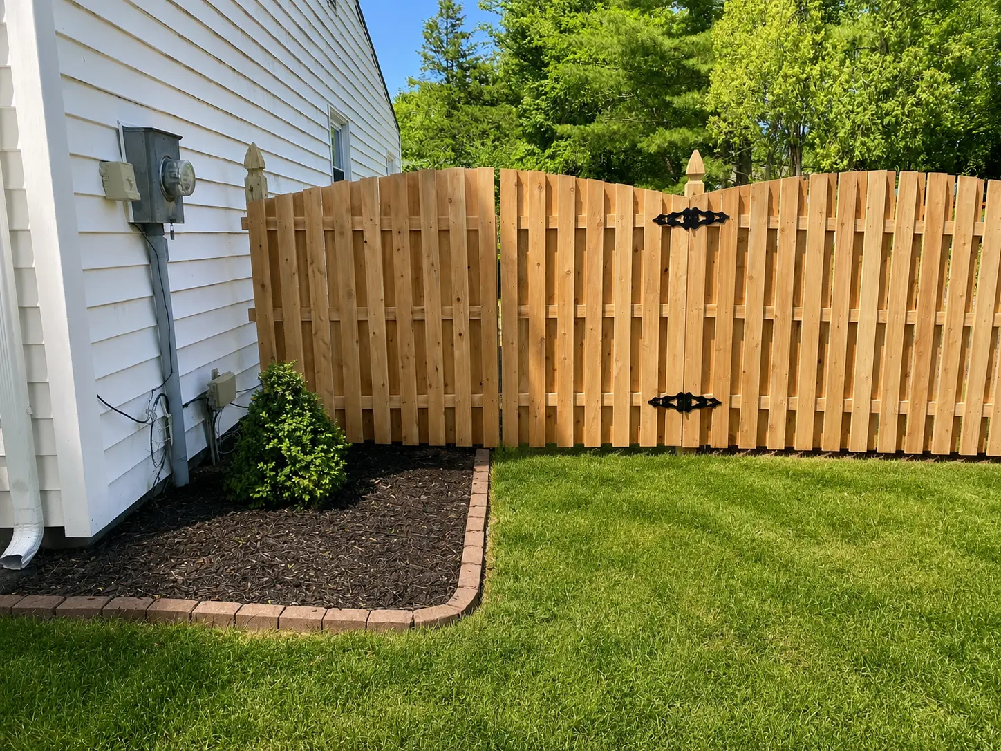 Light cedar shadow box fence with arched top and black decorative gate hinges installed by Fred's Fence in New Jersey