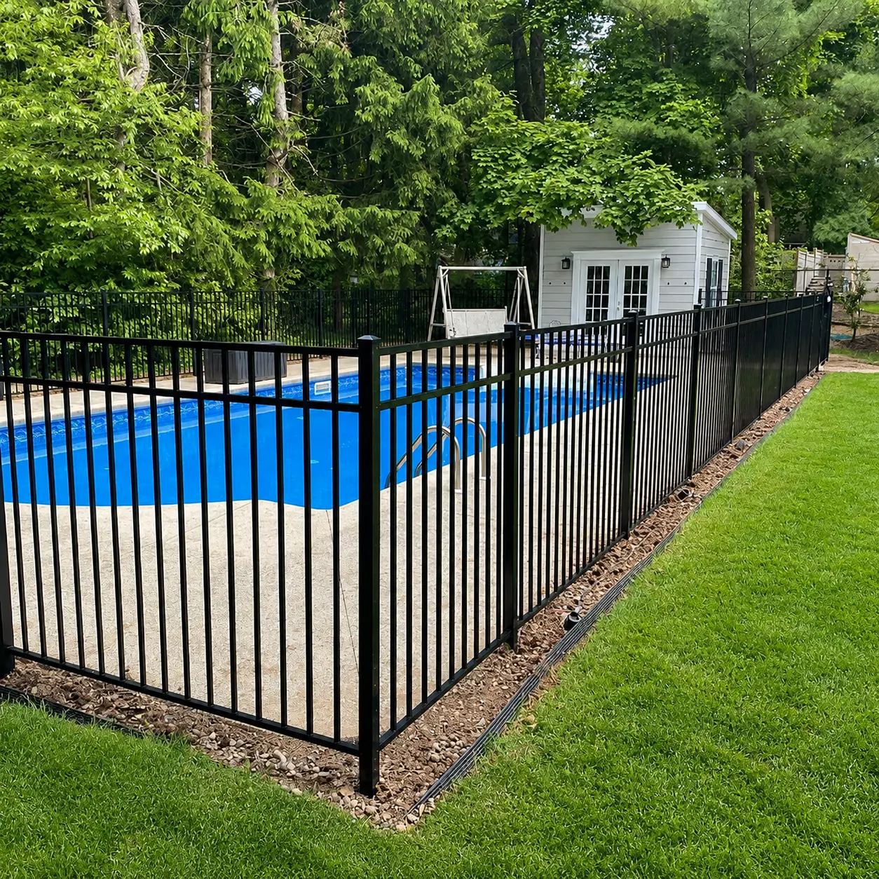 Black aluminum pool code fence installed around an inground pool in New Jersey