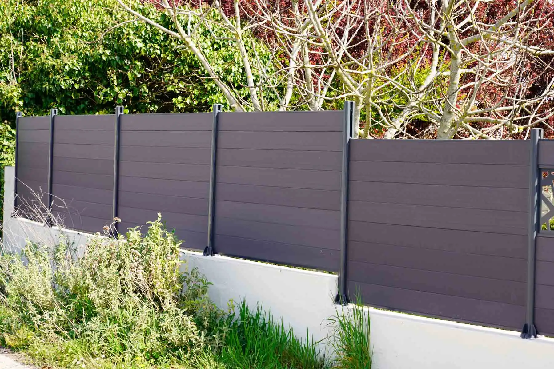 Modern dark gray composite fence panels along a residential property in New Jersey