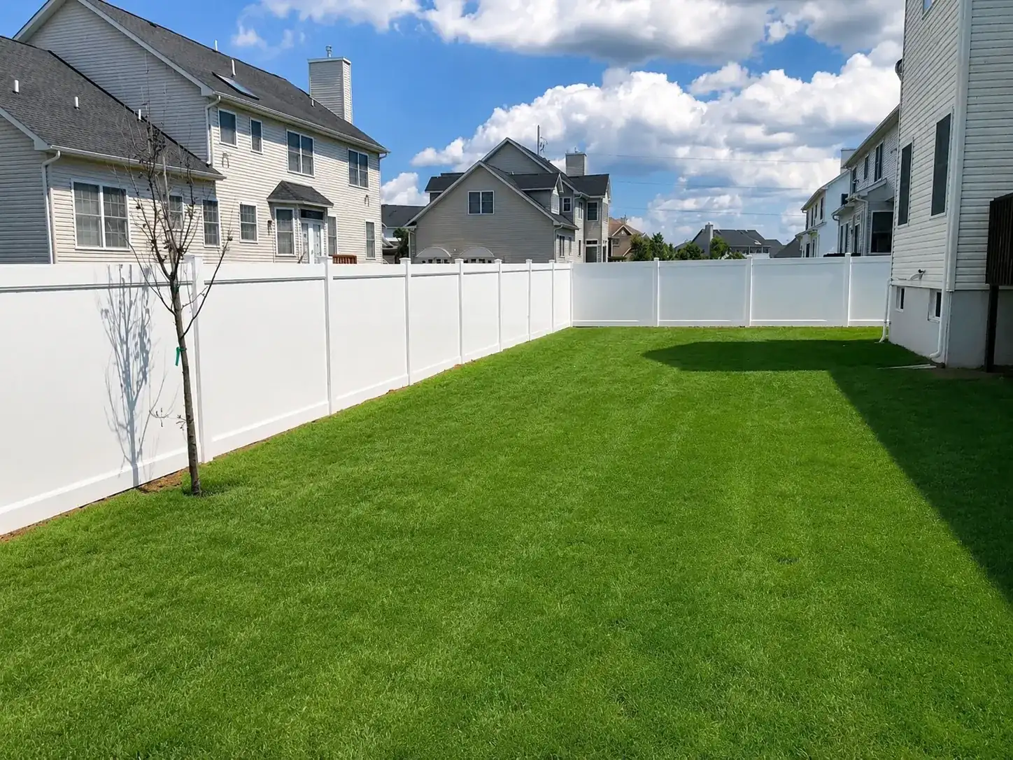 Recent white vinyl privacy fence installation in a New Jersey backyard